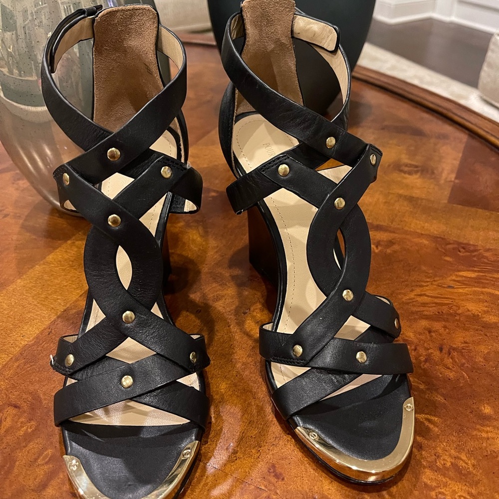 A pair of beautiful Pour La Victoire black wedges with brass toe plate.